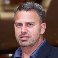 Travis MacMillian | chief business officer